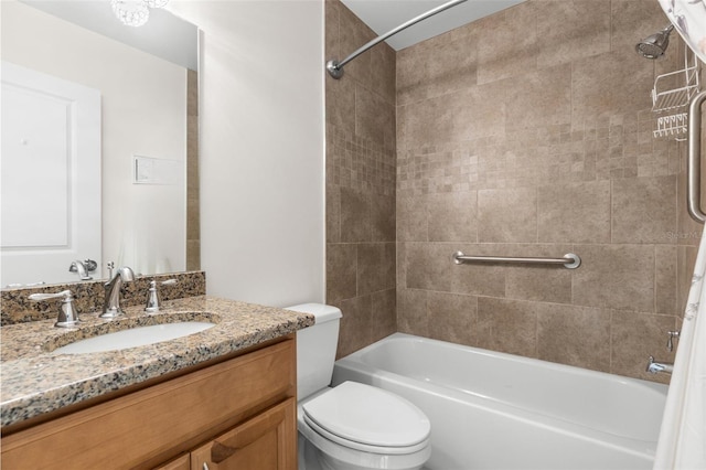 full bathroom featuring vanity, toilet, and tiled shower / bath