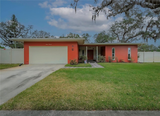 ranch-style house featuring a front lawn and a garage