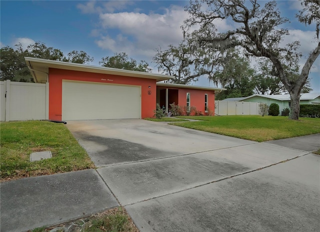 ranch-style home featuring a front lawn and a garage