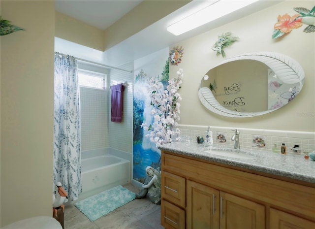 bathroom with decorative backsplash, shower / tub combo, and vanity