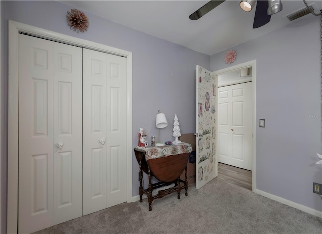 carpeted office featuring ceiling fan