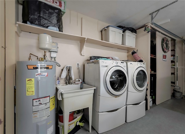 laundry room with water heater, sink, and independent washer and dryer