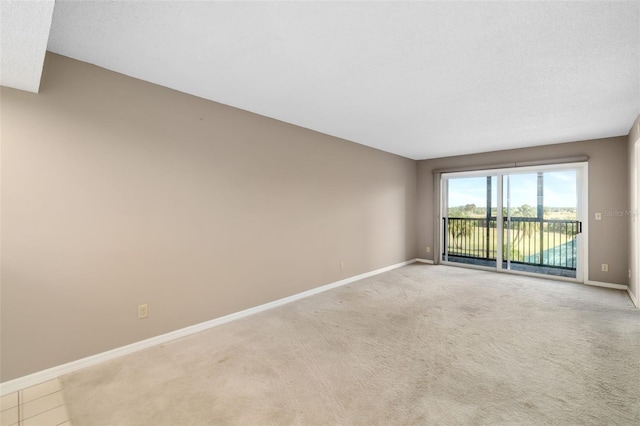 carpeted spare room featuring a textured ceiling