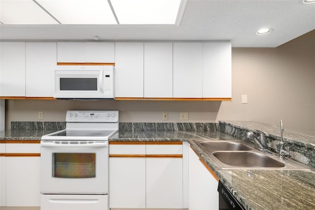 kitchen featuring sink, dark stone counters, a textured ceiling, white appliances, and white cabinets