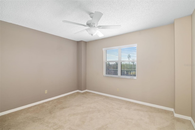 empty room with light carpet, a textured ceiling, and ceiling fan