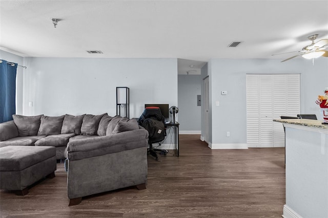 living area featuring ceiling fan, baseboards, visible vents, and dark wood finished floors