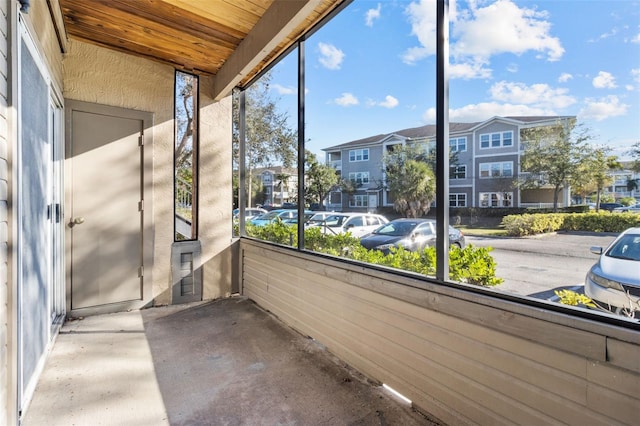 unfurnished sunroom with wood ceiling