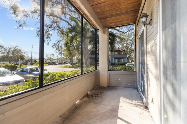 unfurnished sunroom featuring wood ceiling