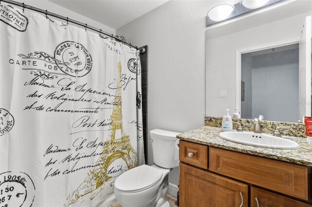 10265 Gandy Blvd N Unit 905, Saint Petersburg, FL 33702 - bathroom with toilet, vanity, a textured wall, and a shower with shower curtain