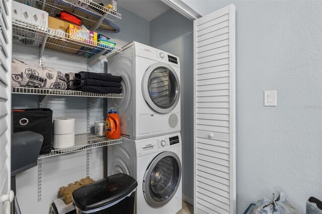 10265 Gandy Blvd N Unit 905, Saint Petersburg, FL 33702 - washroom with stacked washing machine and dryer and a textured wall