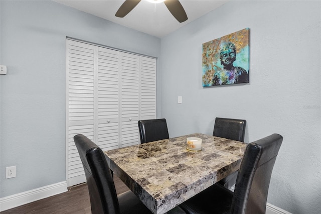 dining space featuring ceiling fan and dark hardwood / wood-style flooring