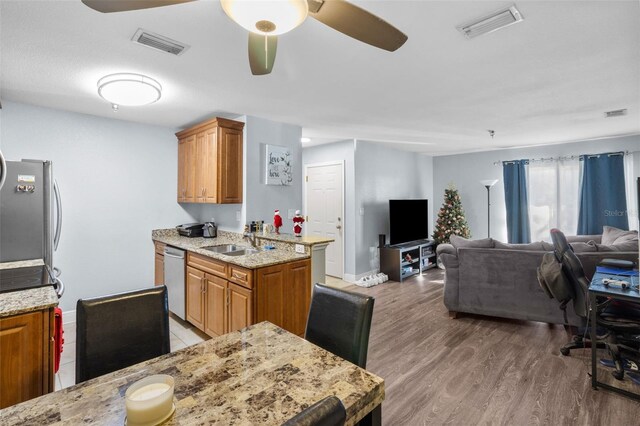 10265 Gandy Blvd N Unit 905, Saint Petersburg, FL 33702 - kitchen with appliances with stainless steel finishes, brown cabinetry, a sink, and ceiling fan