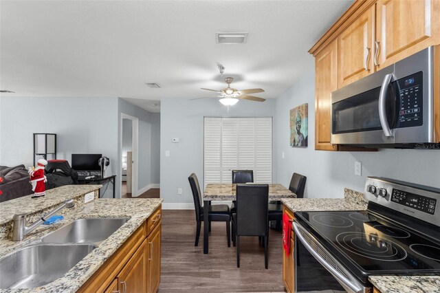 10265 Gandy Blvd N Unit 905, Saint Petersburg, FL 33702 - kitchen featuring stainless steel appliances, a sink, dark wood-style floors, a ceiling fan, and light stone countertops