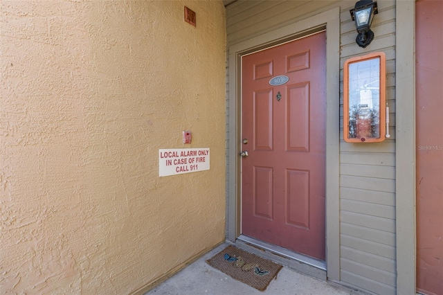 property entrance featuring stucco siding