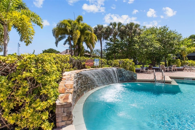 view of pool featuring pool water feature and a patio area