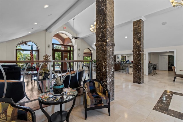 dining room featuring light wood-type flooring, high vaulted ceiling, ornate columns, and ceiling fan