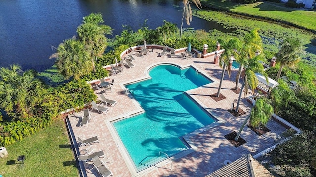 community pool featuring a water view and a patio