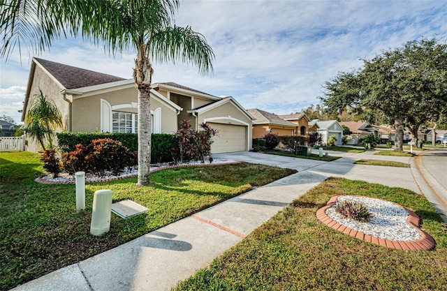 view of front of house featuring a front lawn and a garage