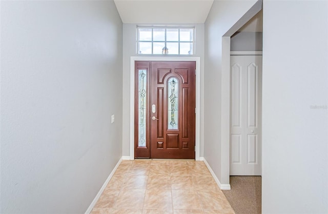 entryway featuring light tile patterned flooring and baseboards