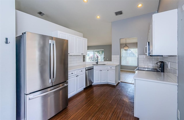 kitchen featuring white cabinets, visible vents, stainless steel appliances, and a sink