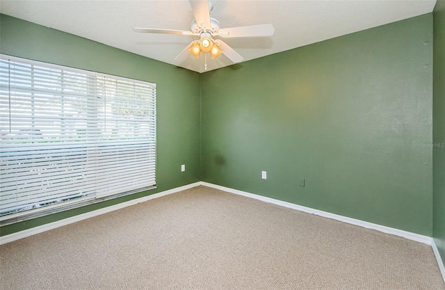 unfurnished room featuring baseboards, a ceiling fan, and carpet flooring