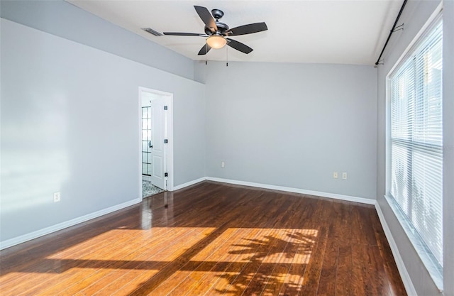 unfurnished room with ceiling fan, wood-type flooring, visible vents, and baseboards