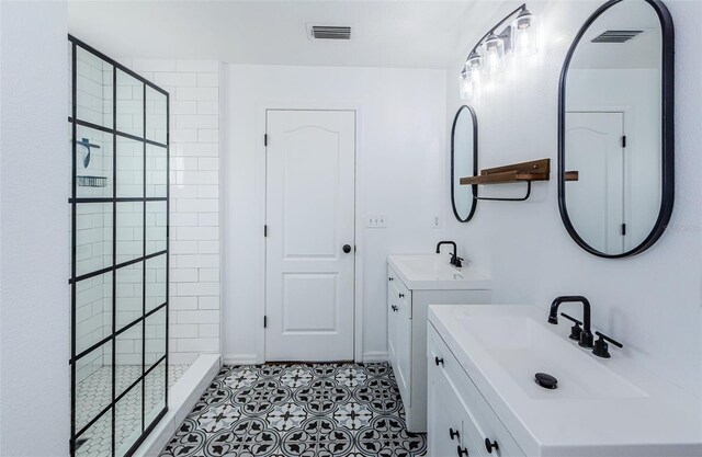 bathroom with walk in shower, a sink, and visible vents