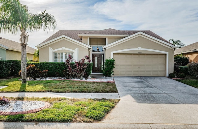 view of front facade featuring a garage, driveway, a shingled roof, and stucco siding