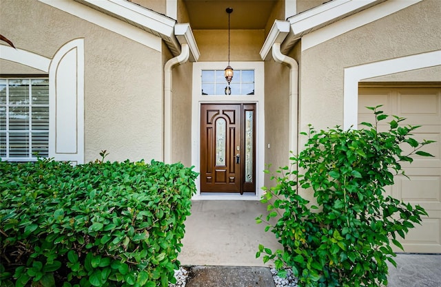 property entrance featuring stucco siding