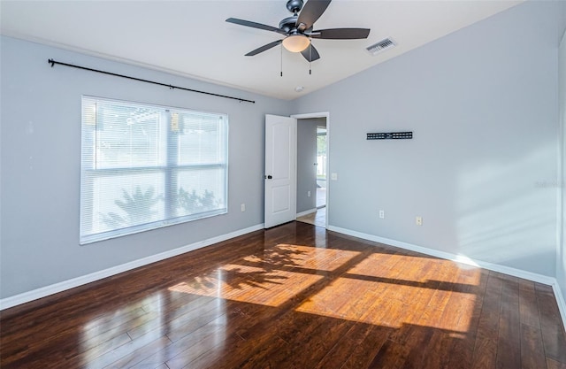 unfurnished bedroom featuring visible vents, hardwood / wood-style floors, and multiple windows