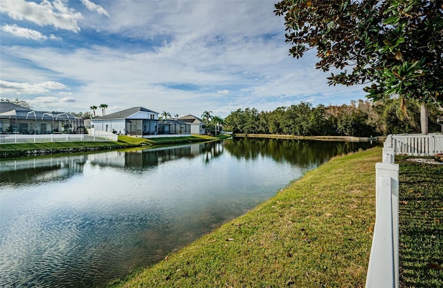 property view of water featuring fence