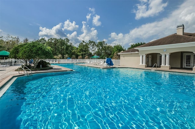 pool featuring fence and a patio