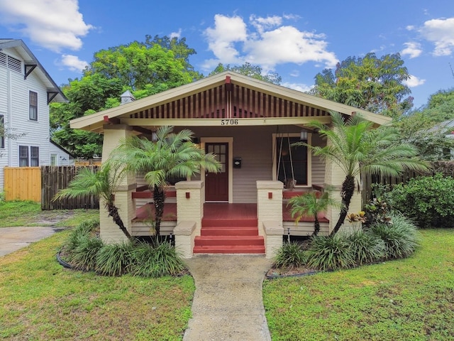 bungalow-style house featuring a porch and a front lawn