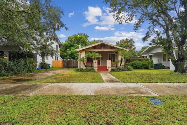 bungalow-style house with a porch and a front lawn