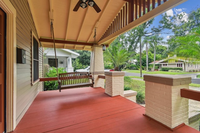 deck featuring covered porch and ceiling fan