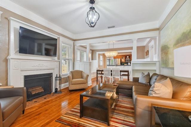 living room featuring hardwood / wood-style floors and an inviting chandelier