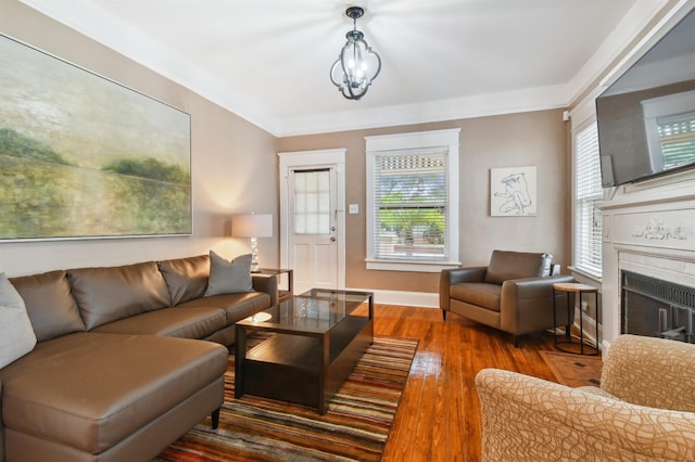 living room featuring dark hardwood / wood-style floors, a wealth of natural light, and a chandelier