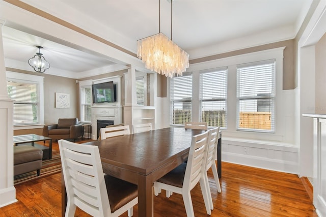 dining space featuring dark hardwood / wood-style floors and an inviting chandelier