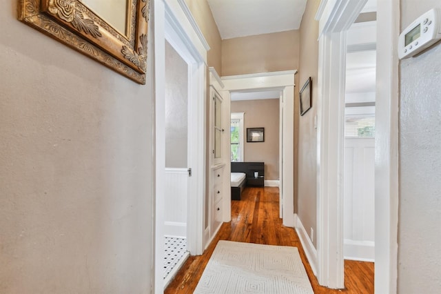 corridor with dark wood-type flooring