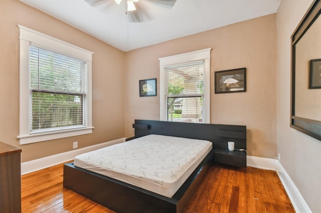 bedroom with ceiling fan and hardwood / wood-style flooring