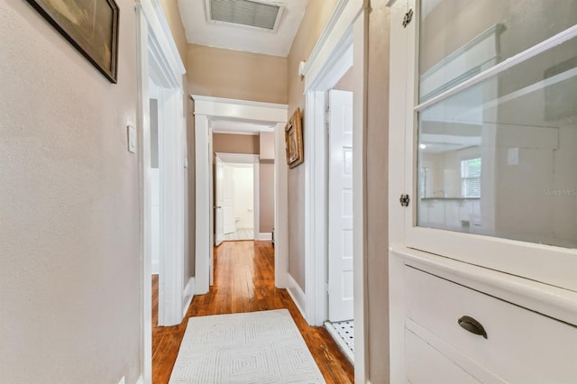 corridor with hardwood / wood-style flooring