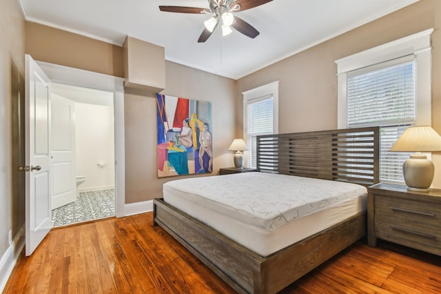 bedroom with multiple windows, ceiling fan, and dark wood-type flooring