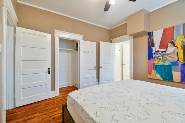 bedroom with a closet, hardwood / wood-style flooring, and ceiling fan