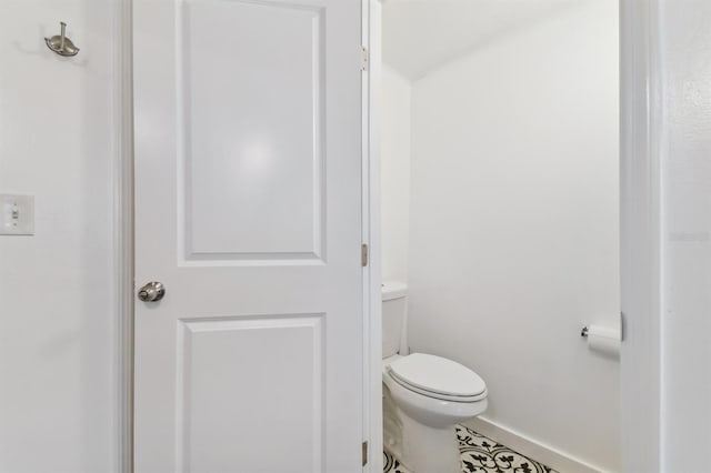 bathroom featuring tile patterned flooring and toilet