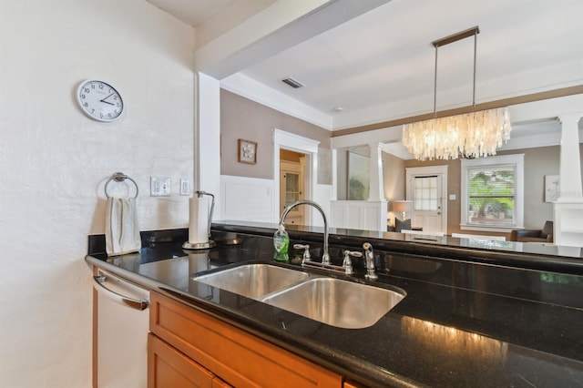 kitchen featuring sink, an inviting chandelier, stainless steel dishwasher, pendant lighting, and dark stone counters