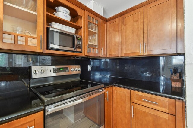 kitchen with tile patterned floors, stainless steel appliances, and tasteful backsplash