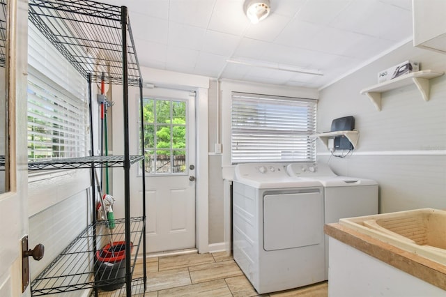 clothes washing area featuring light wood-type flooring and independent washer and dryer