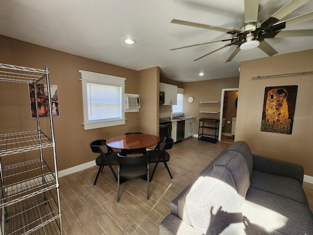 dining room featuring ceiling fan, a wall mounted AC, and light hardwood / wood-style flooring