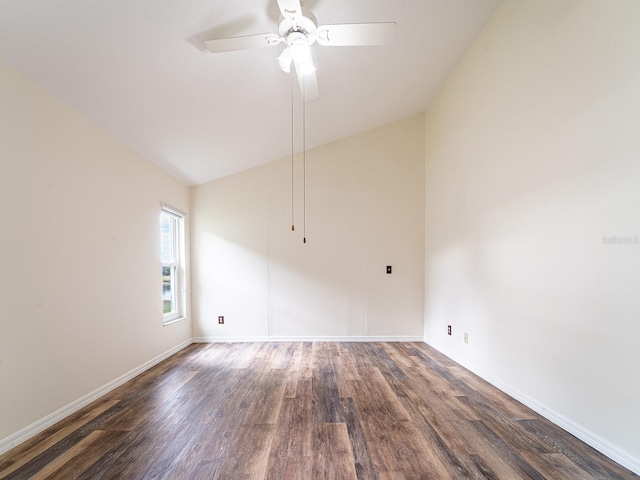 spare room featuring vaulted ceiling, ceiling fan, and dark wood-type flooring