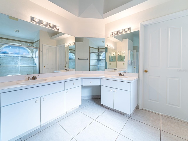 bathroom with tile patterned flooring, vanity, and a shower with shower door